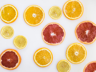 Milk bath with grapefruit, slices of oranges, slices of lemon. Top view