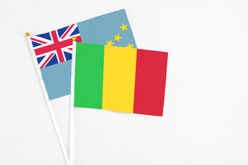 Mali and Tuvalu stick flags on white background. High quality fabric, miniature national flag. Peaceful global concept.White floor for copy space.