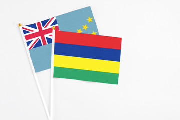 Mauritius and Tuvalu stick flags on white background. High quality fabric, miniature national flag. Peaceful global concept.White floor for copy space.