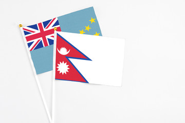 Nepal and Tuvalu stick flags on white background. High quality fabric, miniature national flag....