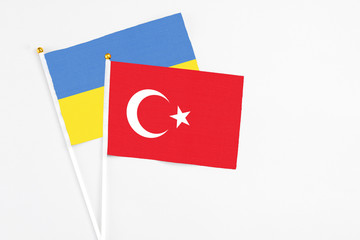 Turkey and Ukraine stick flags on white background. High quality fabric, miniature national flag. Peaceful global concept.White floor for copy space.