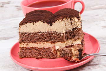 Creamy tiramisu cake with different layers and black coffee. Delicious dessert for celebrations