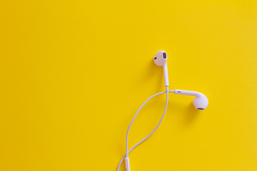 white headphones isolated on yellow background with clipping path. music. space for text. the view from the top