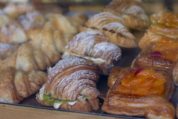 Showcase confectionery delicatessen with a variety of cakes. Pastry shop with doughnuts, cupcakes, creme brulee, cakes. bakery with different types of bakery products