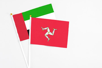 Isle Of Man and United Arab Emirates stick flags on white background. High quality fabric,...