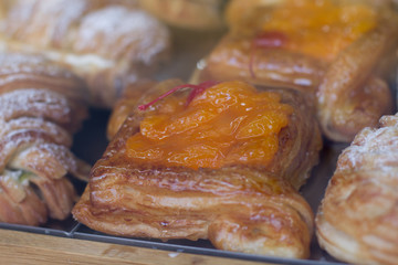 Showcase confectionery delicatessen with a variety of cakes. Pastry shop with doughnuts, cupcakes, creme brulee, cakes. bakery with different types of bakery products