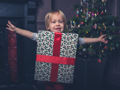 Happy toddler dressed like a present