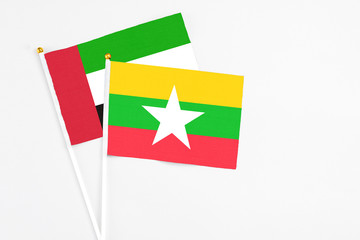 Myanmar and United Arab Emirates stick flags on white background. High quality fabric, miniature national flag. Peaceful global concept.White floor for copy space.