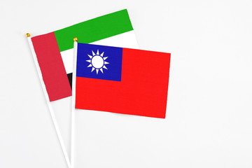 Taiwan and United Arab Emirates stick flags on white background. High quality fabric, miniature national flag. Peaceful global concept.White floor for copy space.