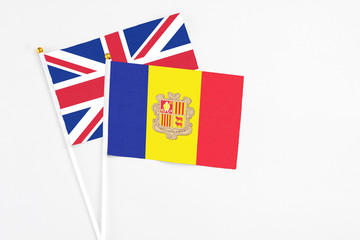 Andorra and United Kingdom stick flags on white background. High quality fabric, miniature national flag. Peaceful global concept.White floor for copy space.