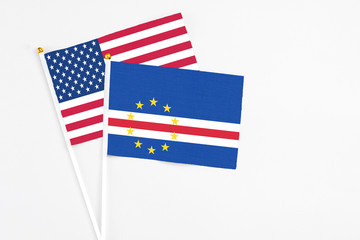Cape Verde and United States stick flags on white background. High quality fabric, miniature national flag. Peaceful global concept.White floor for copy space.