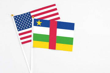 Central African Republic and United States stick flags on white background. High quality fabric, miniature national flag. Peaceful global concept.White floor for copy space.