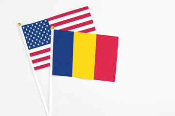 Chad and United States stick flags on white background. High quality fabric, miniature national flag. Peaceful global concept.White floor for copy space.