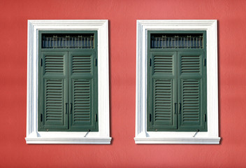 Traditional windows on bright red walls