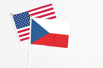 Czech Republic and United States stick flags on white background. High quality fabric, miniature national flag. Peaceful global concept.White floor for copy space.