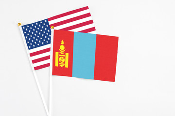 Obraz premium Mongolia and United States stick flags on white background. High quality fabric, miniature national flag. Peaceful global concept.White floor for copy space.