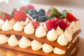 sweet honey cake decorated with raspberry strawberries