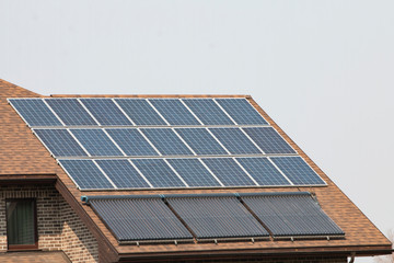 Fototapeta premium Solar panels installed and in use on top of roof of house.
