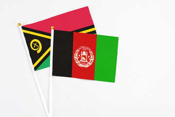 Afghanistan and Vanuatu stick flags on white background. High quality fabric, miniature national flag. Peaceful global concept.White floor for copy space.