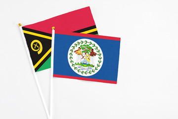Belize and Vanuatu stick flags on white background. High quality fabric, miniature national flag. Peaceful global concept.White floor for copy space.
