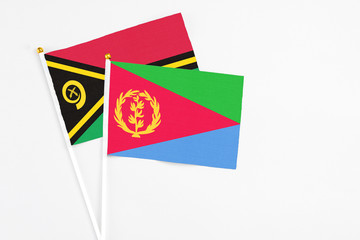 Eritrea and Vanuatu stick flags on white background. High quality fabric, miniature national flag. Peaceful global concept.White floor for copy space.