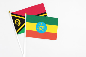 Ethiopia and Vanuatu stick flags on white background. High quality fabric, miniature national flag. Peaceful global concept.White floor for copy space.