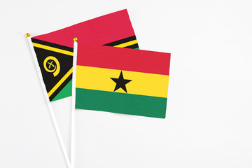 Ghana and Vanuatu stick flags on white background. High quality fabric, miniature national flag. Peaceful global concept.White floor for copy space.