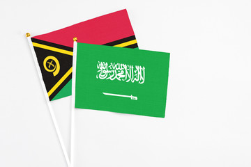 Saudi Arabia and Vanuatu stick flags on white background. High quality fabric, miniature national flag. Peaceful global concept.White floor for copy space.