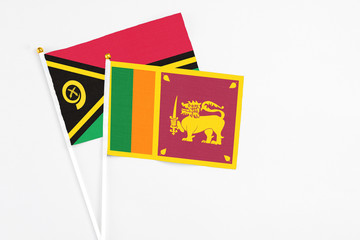 Sri Lanka and Vanuatu stick flags on white background. High quality fabric, miniature national...