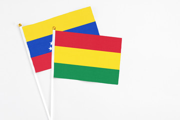 Bolivia and Venezuela stick flags on white background. High quality fabric, miniature national flag. Peaceful global concept.White floor for copy space.