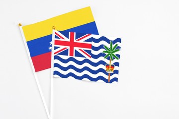 Fototapeta premium British Indian Ocean Territory and Venezuela stick flags on white background. High quality fabric, miniature national flag. Peaceful global concept.White floor for copy space.