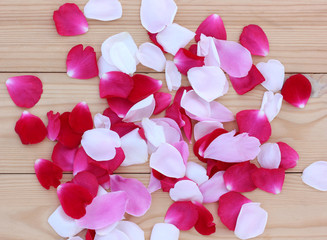 floral background. rose petals on the table, top view.