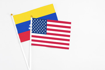 United States and Venezuela stick flags on white background. High quality fabric, miniature national flag. Peaceful global concept.White floor for copy space.