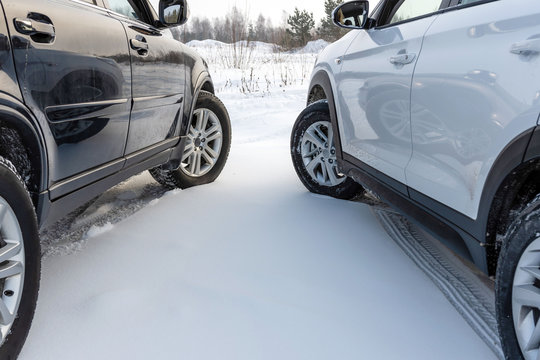 White And Black Suv Car Parked In A Snowy Field.