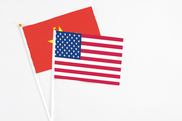 United States and Vietnam stick flags on white background. High quality fabric, miniature national flag. Peaceful global concept.White floor for copy space.