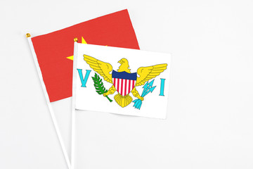 United States Virgin Islands and Vietnam stick flags on white background. High quality fabric, miniature national flag. Peaceful global concept.White floor for copy space.