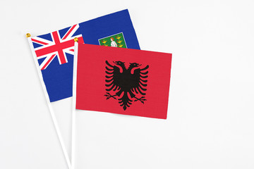 Albania and British Virgin Islands stick flags on white background. High quality fabric, miniature national flag. Peaceful global concept.White floor for copy space.