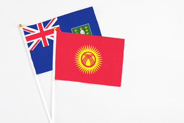 Kyrgyzstan and British Virgin Islands stick flags on white background. High quality fabric, miniature national flag. Peaceful global concept.White floor for copy space.