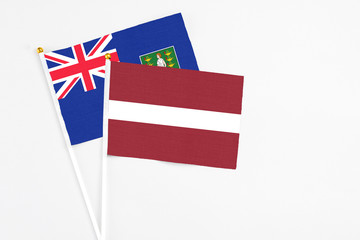 Latvia and British Virgin Islands stick flags on white background. High quality fabric, miniature national flag. Peaceful global concept.White floor for copy space.