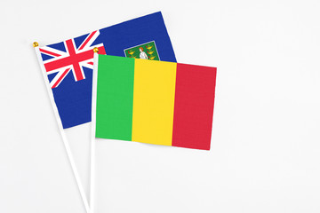 Mali and British Virgin Islands stick flags on white background. High quality fabric, miniature national flag. Peaceful global concept.White floor for copy space.