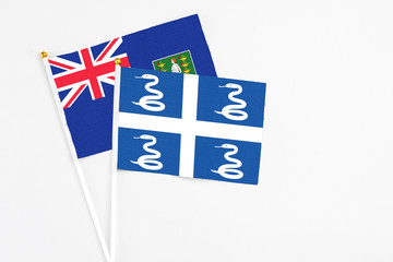 Martinique and British Virgin Islands stick flags on white background. High quality fabric, miniature national flag. Peaceful global concept.White floor for copy space.