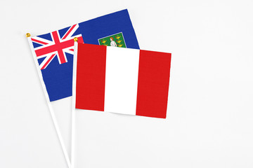 Peru and British Virgin Islands stick flags on white background. High quality fabric, miniature national flag. Peaceful global concept.White floor for copy space.