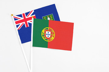 Portugal and British Virgin Islands stick flags on white background. High quality fabric, miniature national flag. Peaceful global concept.White floor for copy space.