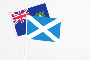Fototapeta premium Scotland and British Virgin Islands stick flags on white background. High quality fabric, miniature national flag. Peaceful global concept.White floor for copy space.
