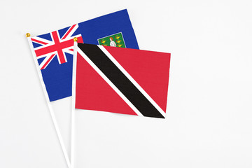 Fototapeta premium Trinidad And Tobago and British Virgin Islands stick flags on white background. High quality fabric, miniature national flag. Peaceful global concept.White floor for copy space.