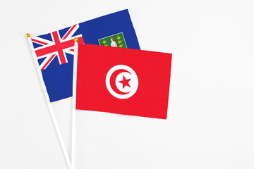 Tunisia and British Virgin Islands stick flags on white background. High quality fabric, miniature national flag. Peaceful global concept.White floor for copy space.