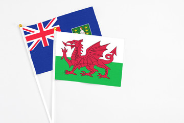 Wales and British Virgin Islands stick flags on white background. High quality fabric, miniature national flag. Peaceful global concept.White floor for copy space.