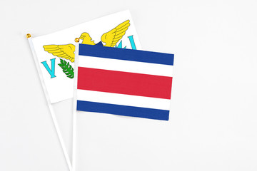 Costa Rica and United States Virgin Islands stick flags on white background. High quality fabric, miniature national flag. Peaceful global concept.White floor for copy space.