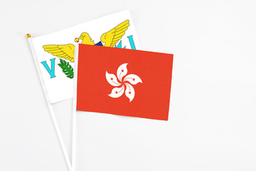 Hong Kong and United States Virgin Islands stick flags on white background. High quality fabric, miniature national flag. Peaceful global concept.White floor for copy space.