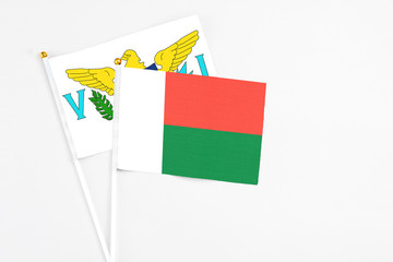 Madagascar and United States Virgin Islands stick flags on white background. High quality fabric, miniature national flag. Peaceful global concept.White floor for copy space.